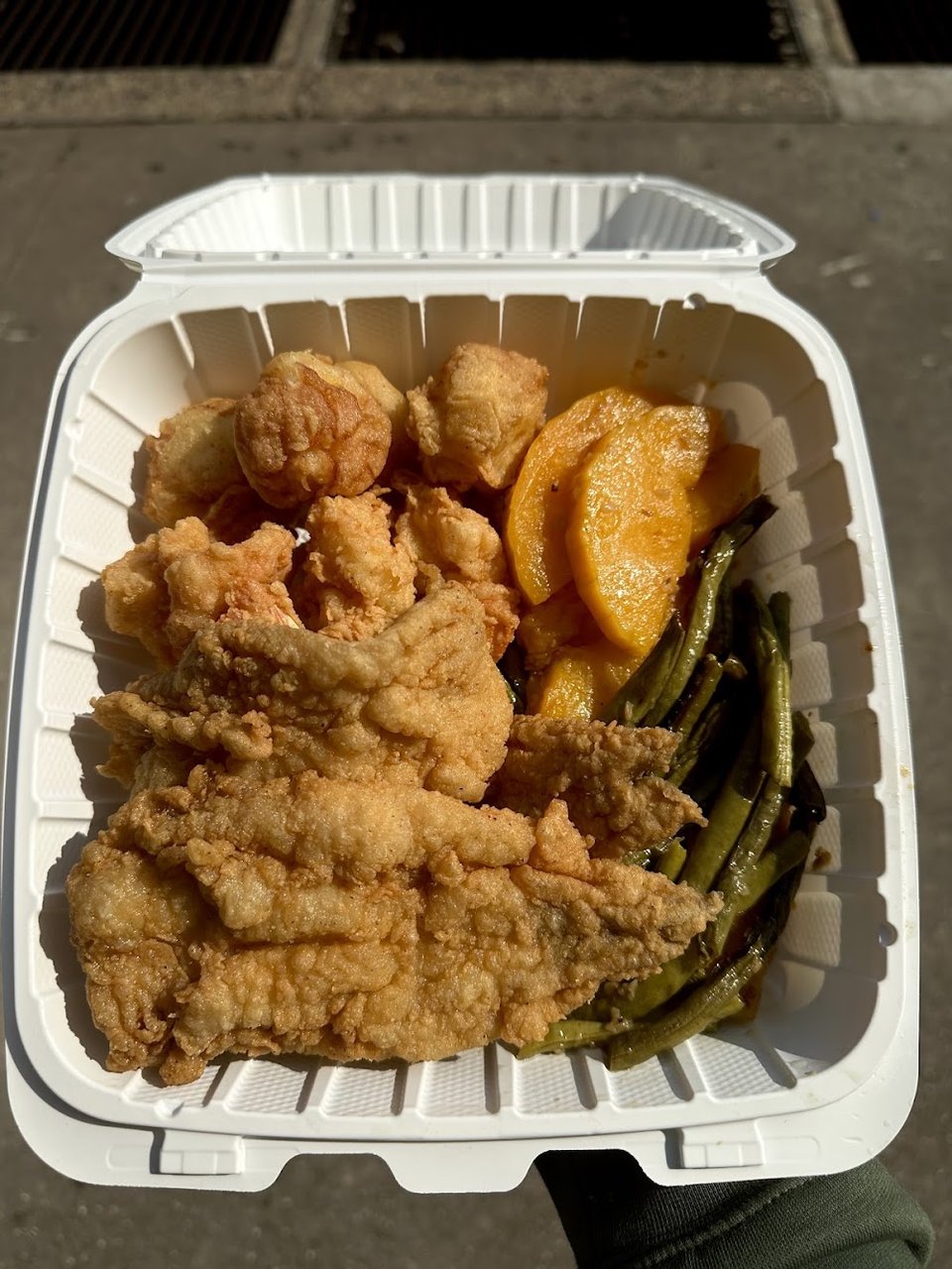 Menu board with seafood dinners and side orders.